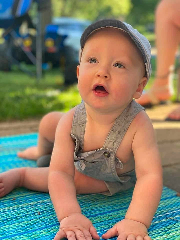 Hartley is registered to the contest to win money with this photo: baby, child, fun, headwear, leisure, person, play, recreation, sitting, skin, smile, summer, surprise, toddler, vacation