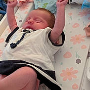 Poppy is registered to the contest to win money with this photo: newborn, baby, infant, clothing, diaper, changing_pad, baby_wipes, stretching, sleeping, pink, white, black, floral_pattern, baby_girl, soft_toys, baby_care, indoors, cute, resting, toddler