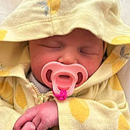 Maddilynn is registered to the contest to win money with this photo: baby, pacifier, sleeping, yellow_clothing, hoodie, infant, hand, closed_eyes, soft_fabric, cute, newborn, peaceful, indoors, cozy, child, portrait, skin, small_hands, comfort, resting