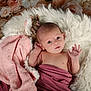 baby, infant, blanket, soft_texture, fluffy_rug, knitted_toy, pink, mauve, flower_background, newborn, portrait, cute, hand, face, eyes, lying_down, cozy, warm, soft_lighting, indoor