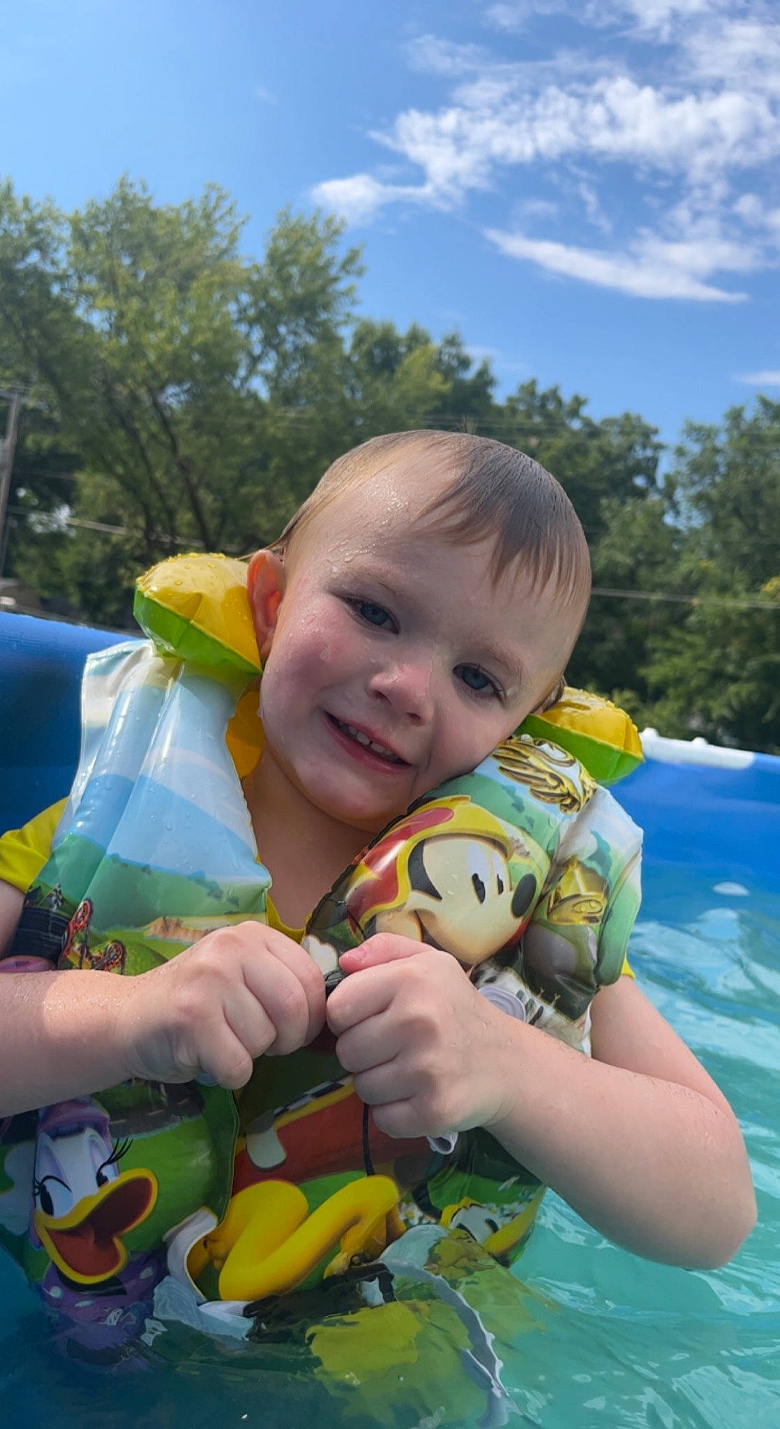 Taylor is registered to the contest to win money with this photo: baby_toddler_clothing, botany, child, cloud, eye, facial_expression, finger, fun, grass, happy, joy, people_in_nature, person, plant, product, skin, sky, smile, toddler, toy