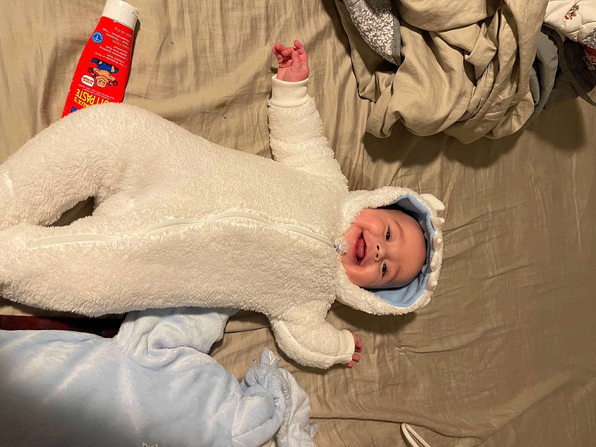 Colton is registered to the contest to win money with this photo: abdomen, baby, baby_products, baby_sleeping, child, comfort, elbow, event, fun, gesture, happy, headgear, human_body, joy, linens, mouth, person, room, sleeve, smile