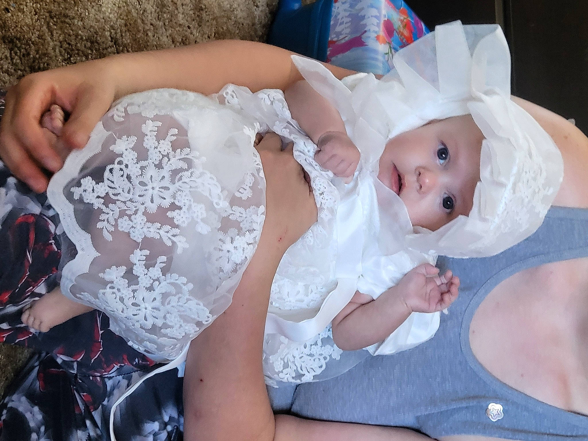 Lydia is registered to the contest to win money with this photo: baby, baby_toddler_clothing, bridal_accessory, child, dress, embellishment, event, eye, fashion_accessory, finger, hair_accessory, happy, hat, headpiece, headwear, human_body, interaction, pattern, person, pink