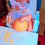 baby, bow, child, high_chair, pumpkin, pumpkin_seeds, table, indoor, mess, curious, plastic_cover, furniture, floor, seat, childhood, exploration, orange, headwear, person, toddler