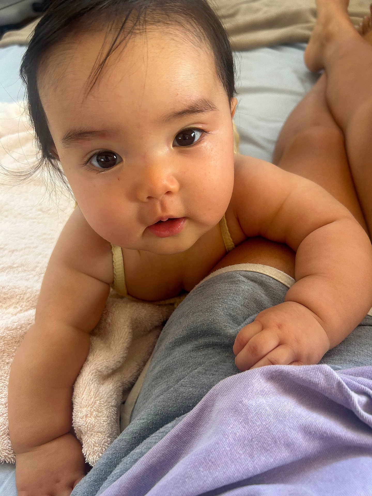 Mizuki joined the competition — help win amazing prizes! baby, infant, face, eyes, arm, hand, skin, towel, clothing, lap, person, closeup, cute, child, resting, indoors, soft, warm, curious, portrait