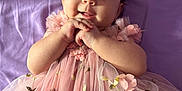 Alidia joined the competition — help win amazing prizes! baby, infant, child, pink_dress, floral_pattern, smiling, hands_clasped, purple_blanket, cute, portrait, lying_down, adorable, face, young_child, happy, tulle, soft_lighting, indoor, close_up, person