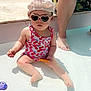 toddler, child, swimsuit, sunglasses, hat, pool, water, toy, adult, legs, sunny, outdoor, playing, summertime, shallow_water, barefoot, summer, cute, sitting, fun