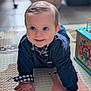baby, child, crawling, blue_eyes, smiling, indoor, play_mat, toy_box, clothing, navy_blue, checkered, cute, happy, portrait, hands, floor, infant, person, young_child, playtime