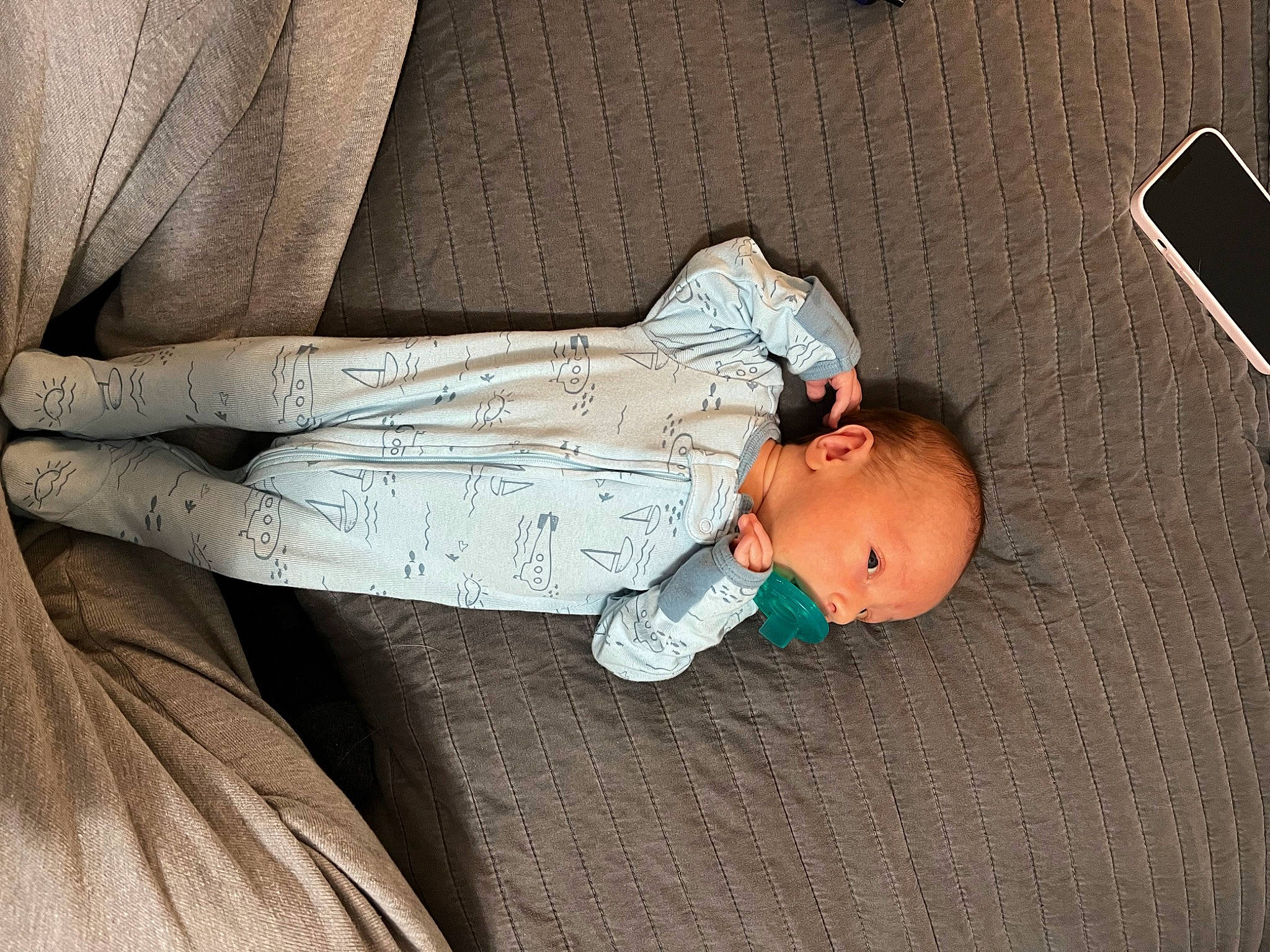 Hudson is registered to the contest to win money with this photo: baby, baby_toddler_clothing, child, comfort, elbow, finger, flooring, hand, human_leg, linens, nap, pattern, person, room, sitting, sleep, sleeve, toddler, wood
