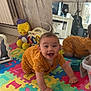 Pablo participe au concours pour gagner de l'argent avec cette photo : baby, crawling, smiling, orange_outfit, play_mat, alphabet, mirror, reflection, stuffed_toy, yellow_toy, guitar, wooden_wall, floor, indoor, child, happy, cute, toy, music, playtime