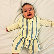 Otis joined the competition — help win amazing prizes! baby, infant, smile, face, clothing, striped_outfit, blanket, lying_down, happy, cute, child, skin, foot, hand, buttoned, knitted, bed, young, one_person, indoors