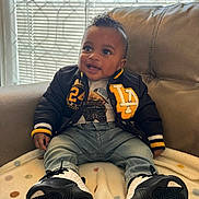 Jaymari is registered to the contest to win money with this photo: baby, blanket, casual, child, clothing, couch, cozy, face, footwear, happy, head, indoor, jacket, jeans, light, person, seated, smile, sneakers, window