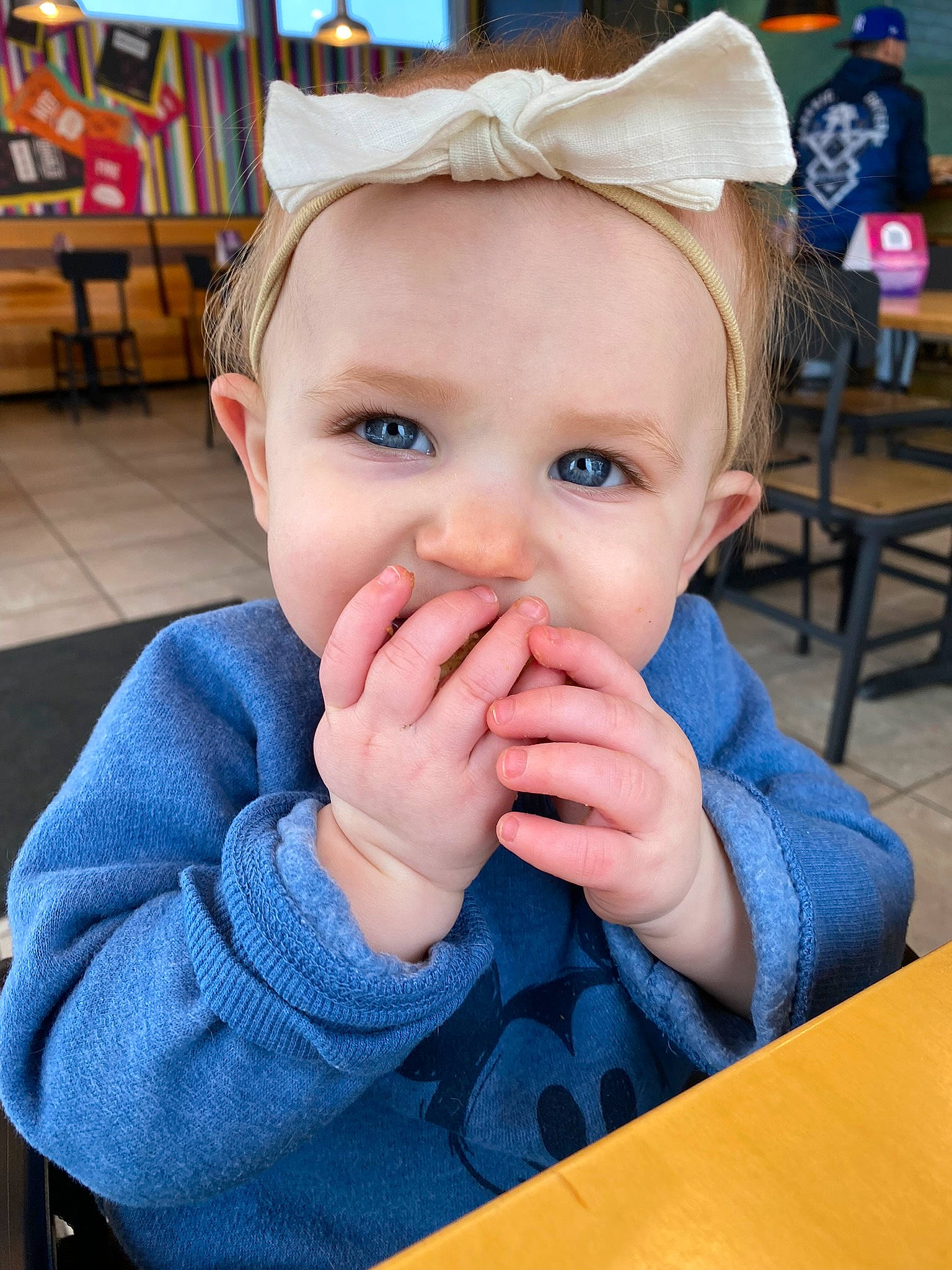 Lindi joined the competition — help win amazing prizes! baby_toddler_clothing, blue, chair, cheek, child, chin, electric_blue, eyelash, fun, gesture, happy, leisure, lip, mouth, nose, person, skin, smile, table, thumb