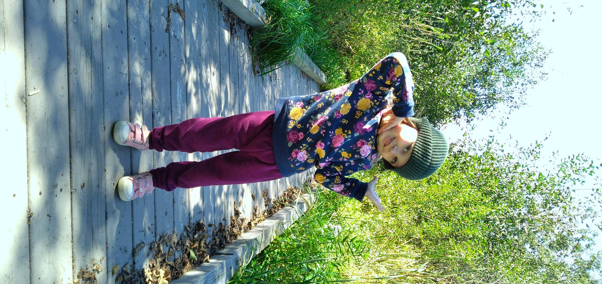 Zelda is registered to the contest to win money with this photo: boot, child, fun, grass, happy, headwear, human_leg, joy, leg, leisure, magenta, people_in_nature, person, plant, purple, recreation, shoe, sitting, sneakers, street_fashion