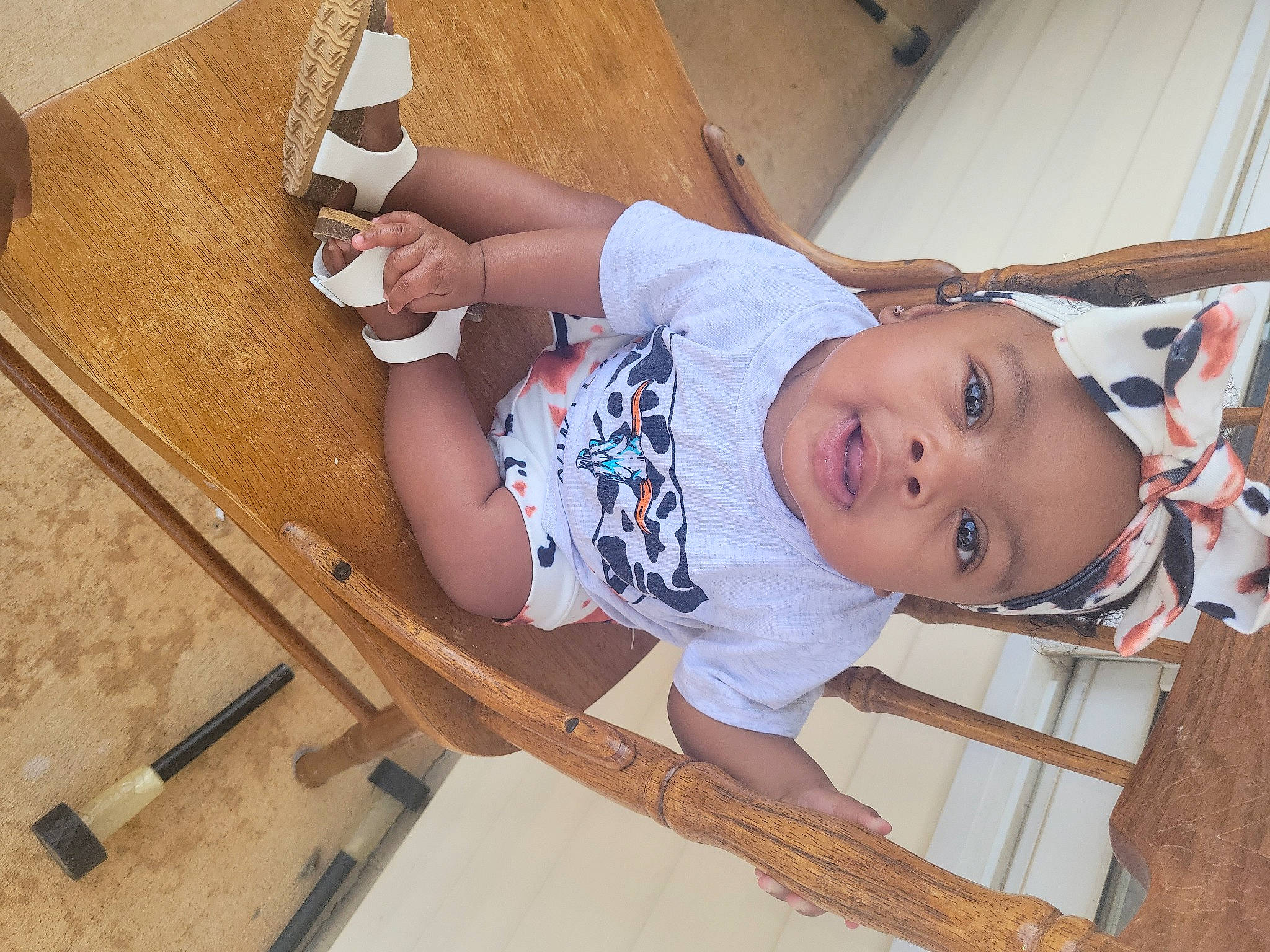 Skyla joined the competition — help win amazing prizes! baby, baby_toddler_clothing, child, comfort, elbow, foot, hardwood, headwear, human_leg, knee, leg, pattern, person, sandal, sitting, sleeve, smile, sock, thigh, toddler