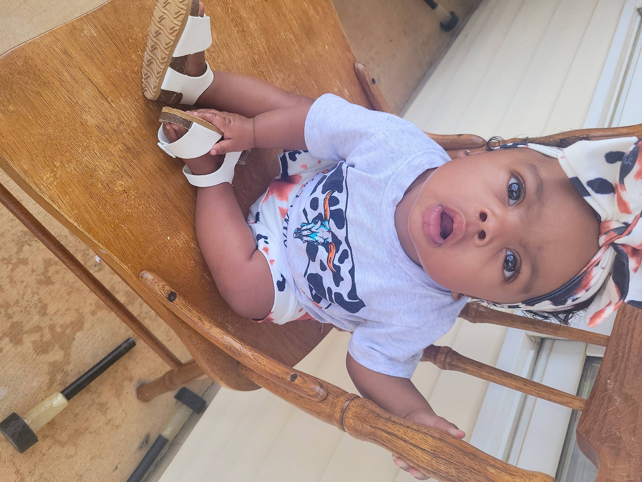 Skyla joined the competition — help win amazing prizes! baby, baby_products, baby_safety, baby_toddler_clothing, child, comfort, elbow, flooring, foot, hardwood, headwear, human_leg, knee, leg, person, room, sitting, sleeve, sock, thigh