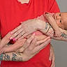 Elyjah joined the competition — help win amazing prizes! arm, baby, care, child, closeup, cute, hand, holding, human, indoor, infant, love, newborn, person, portrait, red_shirt, skin, striped_clothing, tattoo, tenderness
