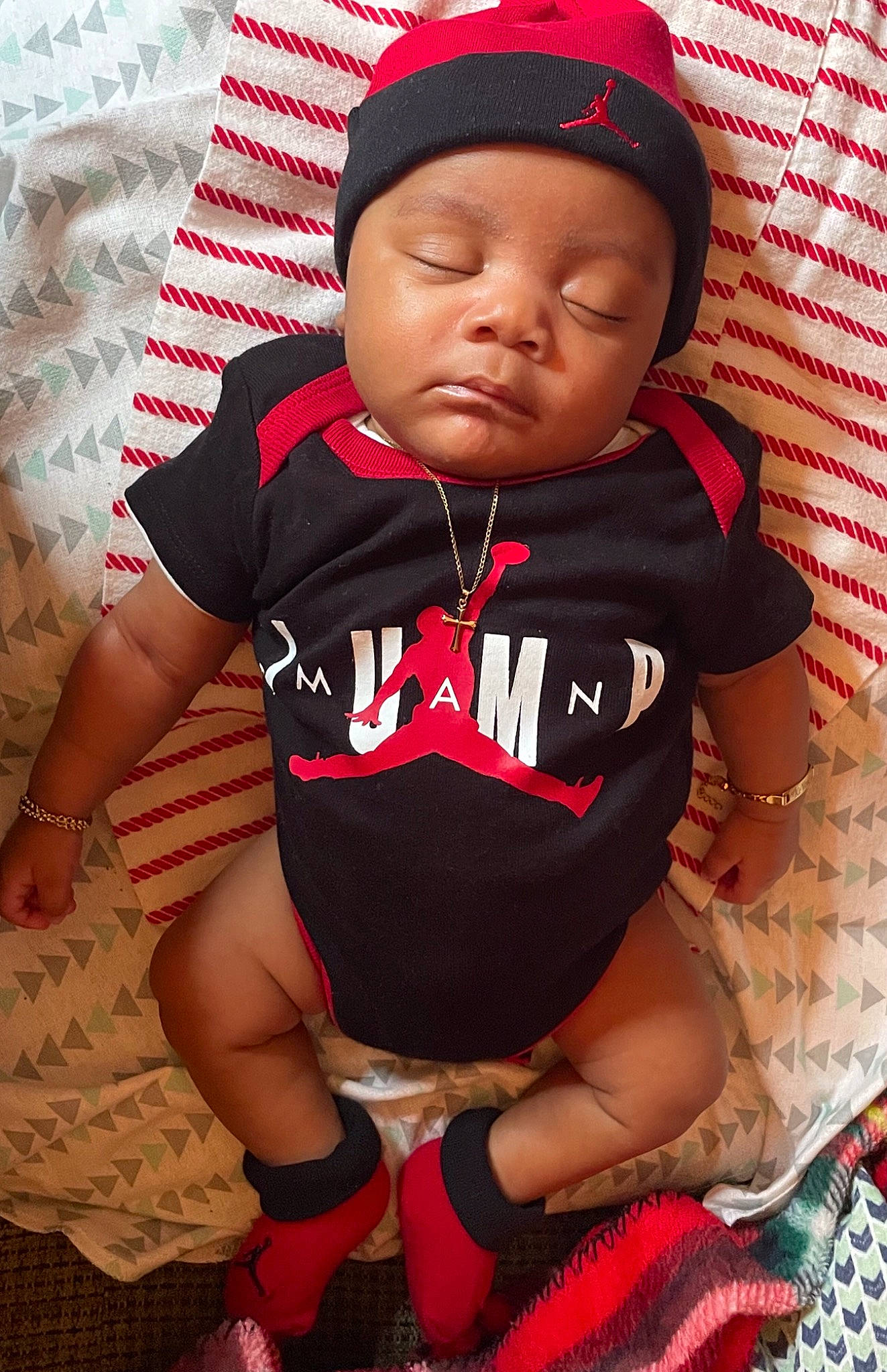 Kevon joined the competition — help win amazing prizes! baby, baby_sleeping, baby_toddler_clothing, cap, comfort, eye, face, finger, happy, headgear, headwear, lip, mouth, neck, orange, person, pink, red, skin, sleeve