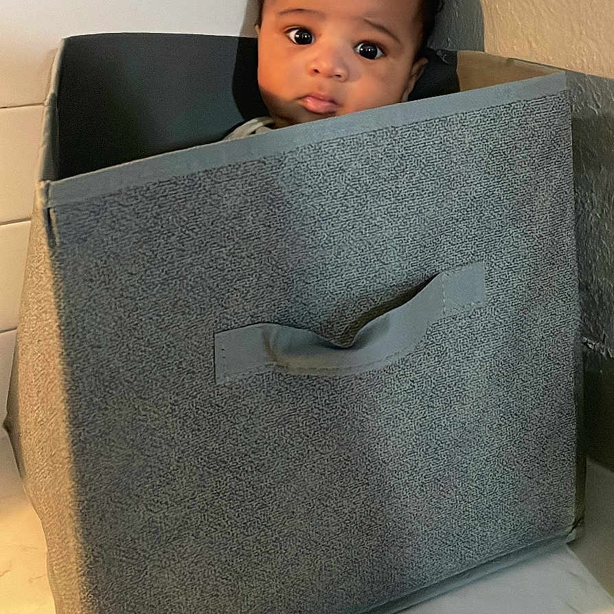 Amoris joined the competition — help win amazing prizes! baby, child, container, countertop, curious, cute, expression, fabric, face, handle, indoor, kitchen, light, person, portrait, seated, shadow, storage_bin, tile_wall, young_child