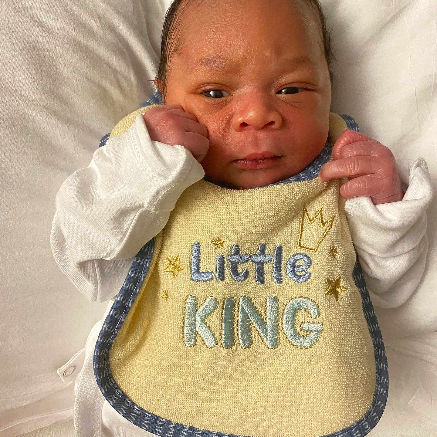 Leroi joined the competition — help win amazing prizes! baby, bib, child, clothing, cute, expression, fabric, face, hands, head, indoors, infant, lying_down, newborn, portrait, resting, skin, small, soft, white