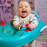 Grace joined the competition — help win amazing prizes! baby, smiling, walker, onesie, indoor, happy, child, face, hands, toy, background, purple, roses, text, floor, playtime, cute, infant, person, colorful