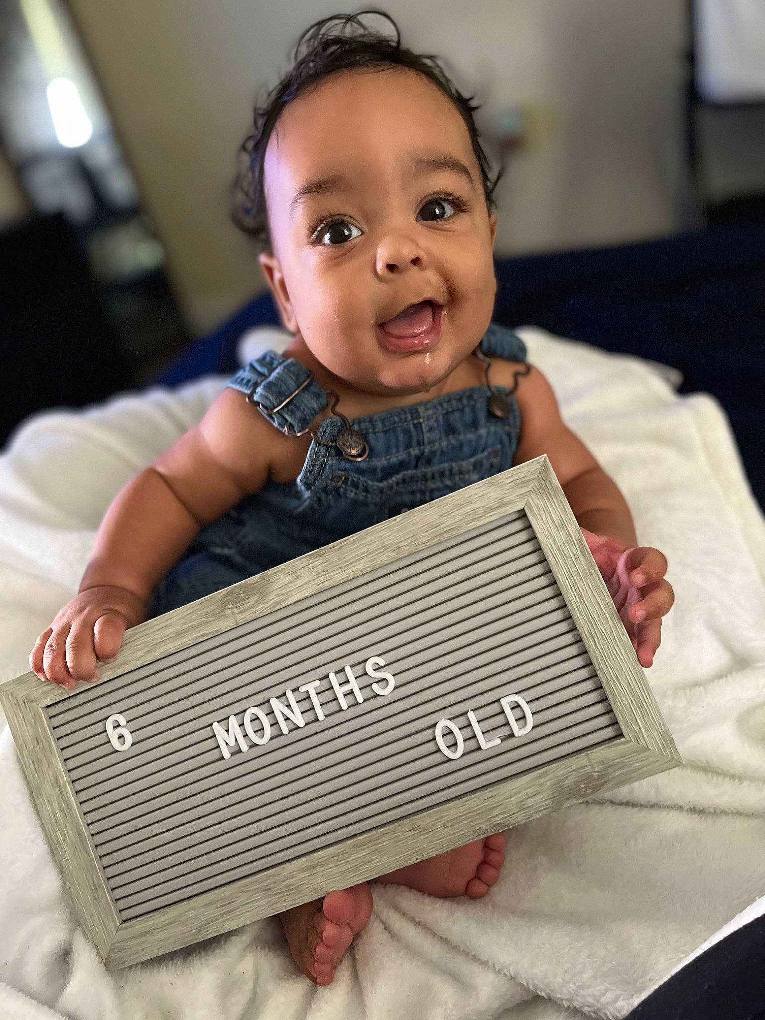 Hezekiah is registered to the contest to win money with this photo: audio_equipment, baby, baby_toddler_clothing, baggage, child, comfort, electronic_device, electronic_instrument, fashion_accessory, flooring, gadget, happy, pattern, person, photograph, portrait_photography, product, room, sitting, toddler