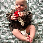 Forrest is registered to the contest to win money with this photo: baby, blanket, bodypart, clothing, couch, face, finger, furniture, hand, happy, head, knitwear, newborn, pants, person, photography, portrait, quilt, sitting, sweater