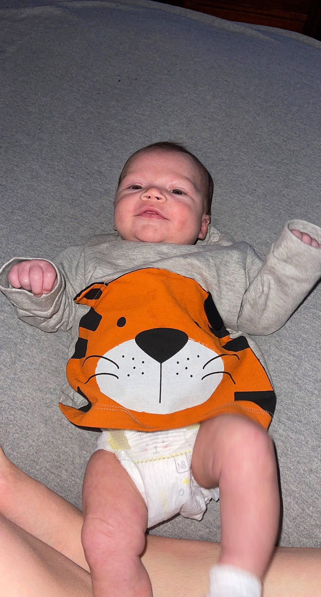 Waylon joined the competition — help win amazing prizes! baby_toddler_clothing, finger, gesture, hand, happy, human_body, mouth, muscle, orange, organ, person, personal_protective_equipment, skin, sleeve, smile, t_shirt, textile, thigh, thumb, toy