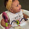 baby, baby_walker, bib, child, closeup, clothing, cute, face, hand, happy, headband, indoor, infant, person, play, seated, skin, smiling, toy, young_child