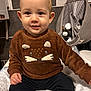 Eden participe au concours pour gagner de l'argent avec cette photo : baby, child, sweater, brown_clothing, animal_design, face, eyes, hand, blanket, indoor, bathroom, toiletries, container, seated, cute, smiling, person, young, toddler, comfort