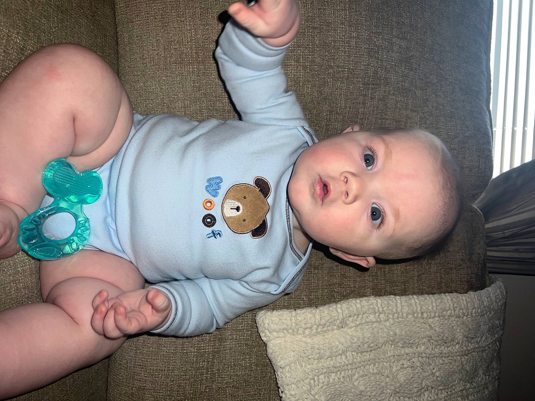 Damien is registered to the contest to win money with this photo: baby, baby_products, baby_toddler_clothing, cheek, chest, child, comfort, elbow, gesture, hand, human_leg, person, sitting, skin, sleeve, stomach, thigh, thumb, toddler, wood
