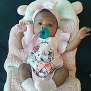 Keniya joined the competition — help win amazing prizes! baby, infant, pacifier, pink_outfit, headband, blanket, soft_texture, cartoon_elephant, cute, lying_down, small_hands, white_socks, child, adorable, indoors, portrait, baby_clothing, toddler, comfort, sleeping_area