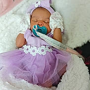 Keniya joined the competition — help win amazing prizes! baby, infant, sleeping, pacifier, lavender_dress, headband, mittens, blanket, cozy, cute, floral, tulle, soft, newborn, portrait, child, indoor, pink, white, resting