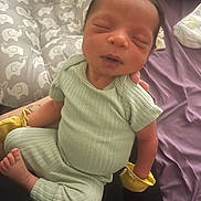 Treshaun is registered to the contest to win money with this photo: newborn, baby, infant, sleeping, clothing, mittens, elephant_pattern, cushion, soft, cozy, child, resting, peaceful, portrait, indoor, person, cute, small, hands, feet