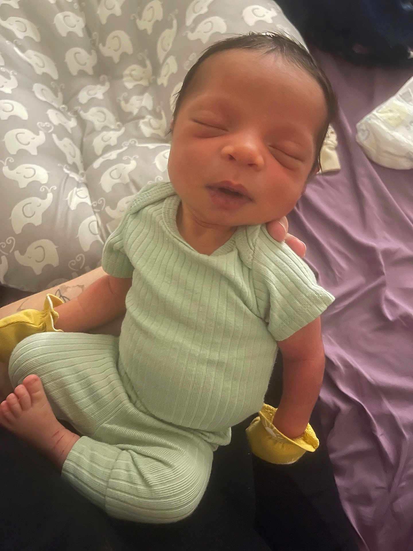 Treshaun is registered to the contest to win money with this photo: newborn, baby, infant, sleeping, clothing, mittens, elephant_pattern, cushion, soft, cozy, child, resting, peaceful, portrait, indoor, person, cute, small, hands, feet