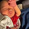 Jericho is registered to the contest to win money with this photo: newborn, baby, infant, sleeping, portrait, face, hand, raised_hand, red_clothing, blanket, wrapped, cozy, indoors, bed, bedding, peaceful, eyes_closed, tiny_fingers, baby_clothes, photography