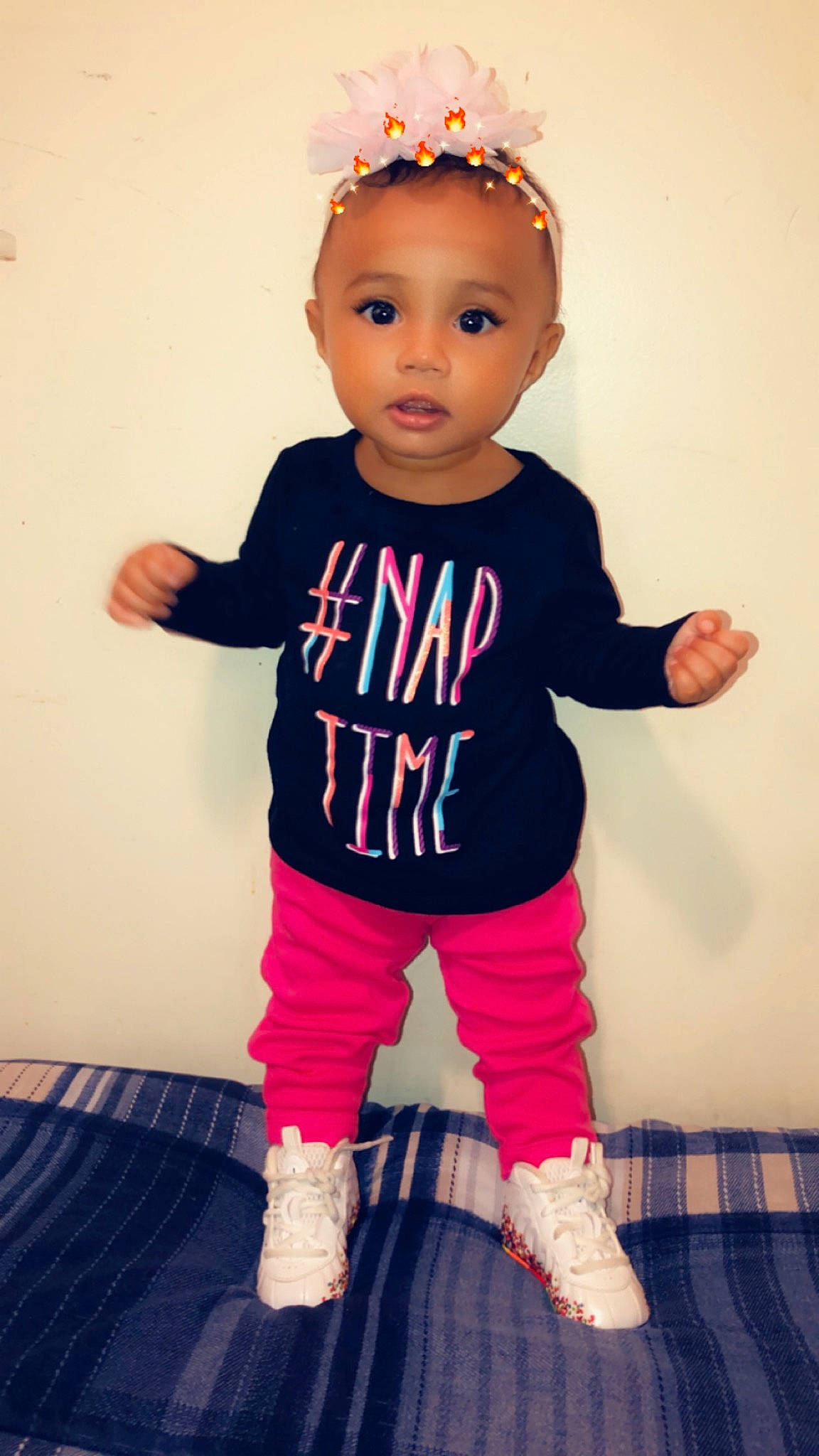 Aminah is registered to the contest to win money with this photo: baby, baby_toddler_clothing, cheek, child, clothing, costume, footwear, head, jeans, joint, leggings, person, pink, shoe, sleeve, standing, t_shirt, toddler, trousers, yellow