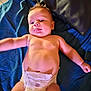 Giorgio participe au concours pour gagner de l'argent avec cette photo : baby, infant, diaper, tongue_out, lying_down, blanket, pillow, skin, arm, hand, cute, child, indoors, playful, expression, young, person, head, torso, leg