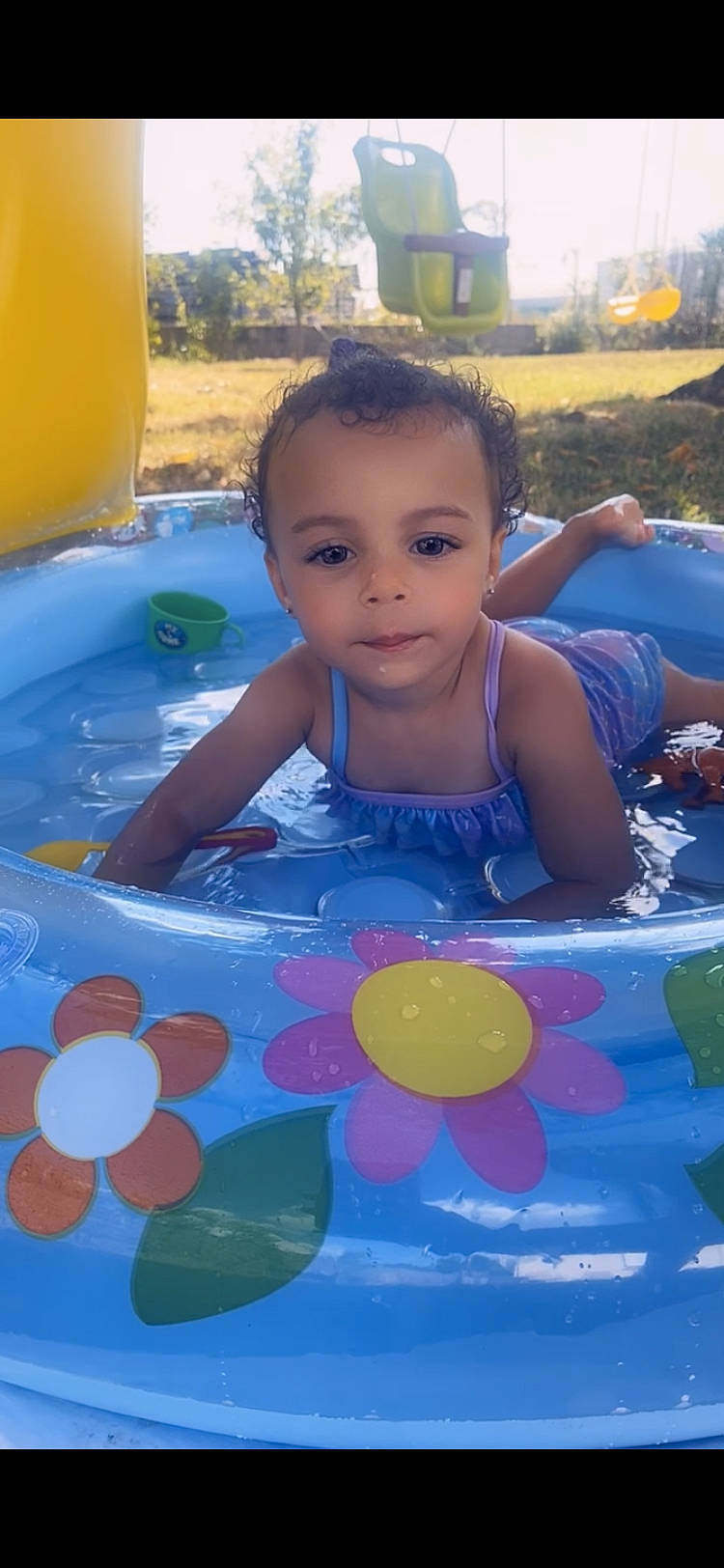 Thelma participe au concours pour gagner de l'argent avec cette photo : baby_products, baby_toddler_clothing, bathing, beauty, blue, child, facial_expression, fun, happy, leisure, light, pattern, person, play, product, public_space, recreation, summer, toddler, water