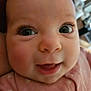 baby, close_up, face, smile, pink_clothing, infant, child, eyes, long_eyelashes, cute, portrait, happy, skin, baby_clothes, person, young_child, head, indoors, expression, cheeks
