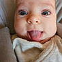 baby, face, tongue, close_up, expression, infant, blanket, cute, child, skin, eyes, mouth, person, clothing, indoors, soft, adorable, silly, wrapped, portrait