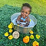 baby, child, bucket, bath, bubbles, rubber_duck, toy, greenery, grass, outdoor, smiling, cute, water, playful, blue_bow_tie, infant, seven_months, happy, face, portrait