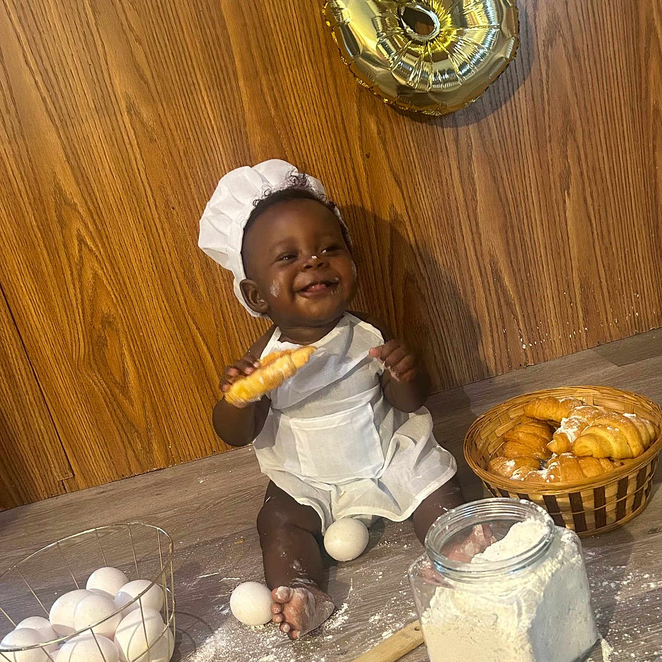 Cotie is registered to the contest to win money with this photo: apron, baby, baking, balloon, basket, celebration, chef_hat, child, cooking, croissant, eggs, floor, flour, food, happy, indoor, kitchen, portrait, smiling, wooden_spoon