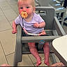 baby, casual, chair, child, curious, cute, floor_tiles, high_chair, indoor, infant, legs, modern_furniture, pacifier, person, pink_clothing, playful, restaurant, seated, table, tattoo