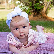 Ryleigh joined the competition — help win amazing prizes! baby, child, infant, blue_eyes, white_headband, pink_dress, blanket, outdoor, grass, sunlight, portrait, cute, tummy_time, garden, nature, young_child, face, expression, summer, playtime