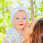 Ryleigh joined the competition — help win amazing prizes! affection, baby, child, closeup, face, family, flower_pattern, greenery, happy, headband, holding, kiss, love, nature, outdoor, person, portrait, smile, sunlight, woman