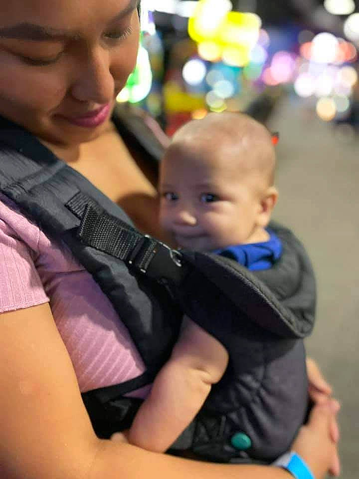 Marcos is registered to the contest to win money with this photo: arm, baby, child, event, eye, face, facial_expression, fun, grass, happy, jewellery, leisure, person, product, recreation, sitting, skin, smile, toddler, tree