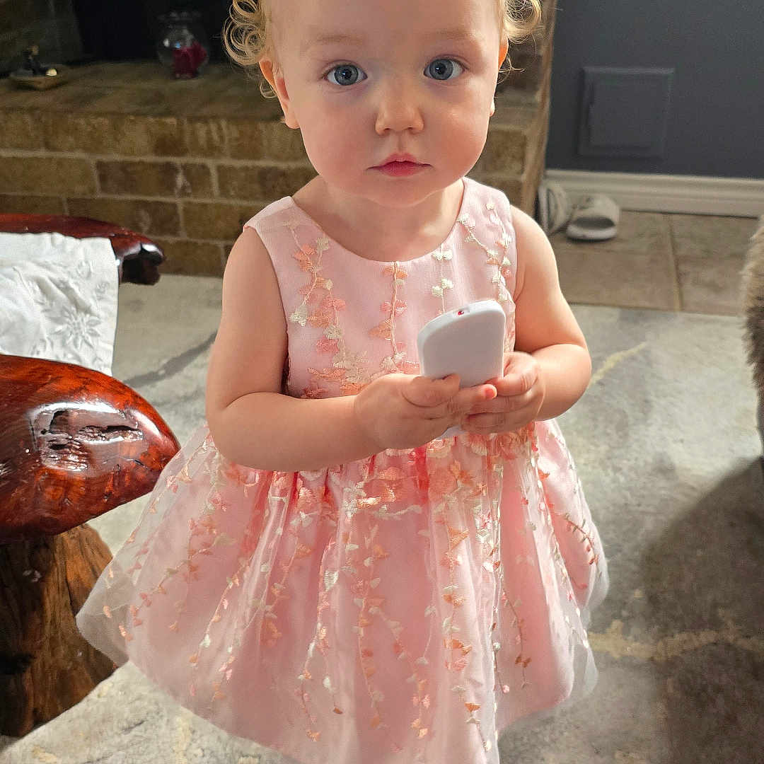 Husna joined the competition — help win amazing prizes! child, clothing, cream, dessert, dress, electronics, face, female, food, footwear, furniture, girl, head, indoors, person, phone, photography, portrait, shoe, sitting