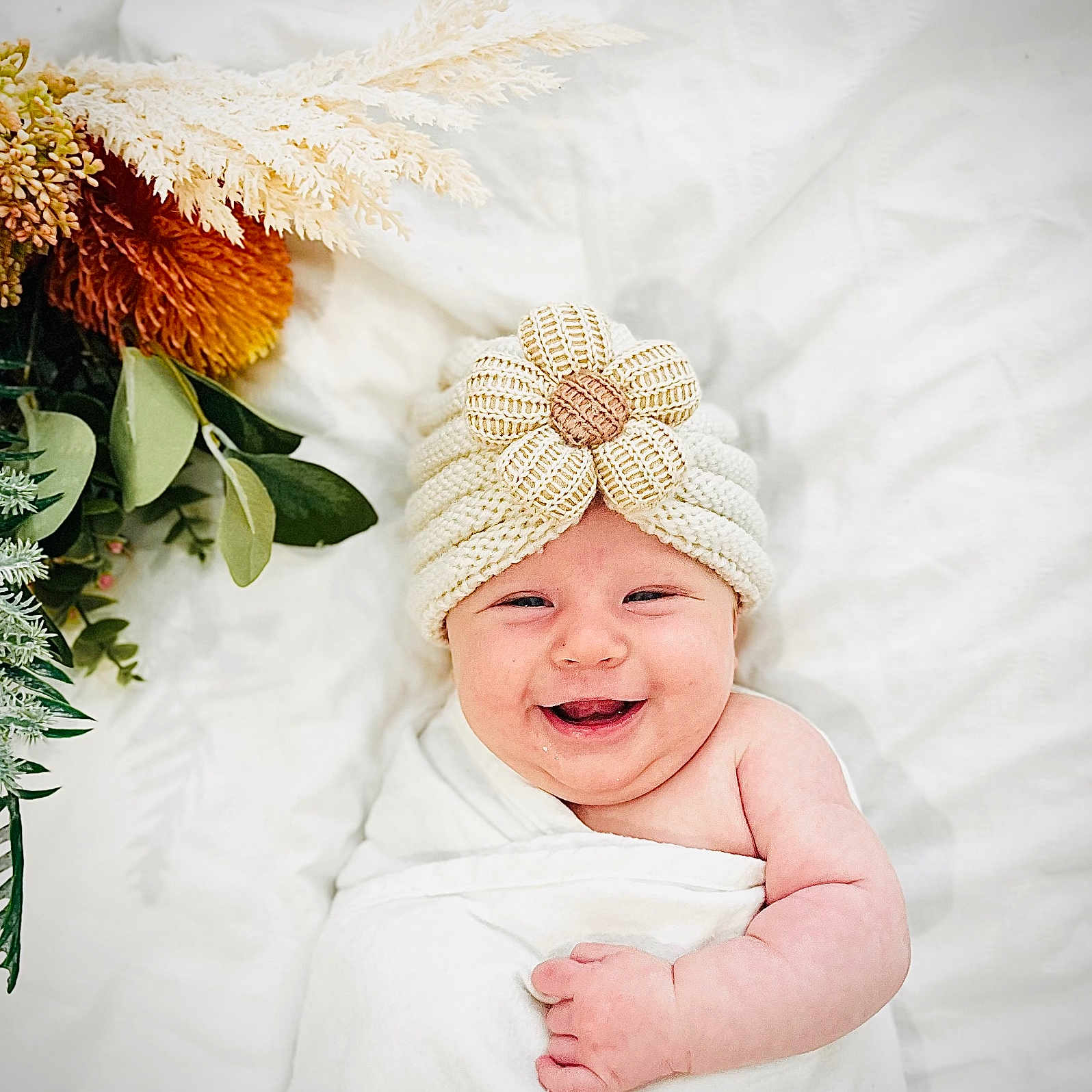 Ava is registered to the contest to win money with this photo: baby, babylaughing, cap, clothing, face, flower, flowerarrangement, flowerbouquet, furniture, happy, hat, head, laughing, leaf, newborn, person, photography, plant, portrait, smile
