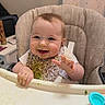 Riley joined the competition — help win amazing prizes! baby, high_chair, messy, food, smiling, happy, bib, face, hand, indoor, child, feeding, green_food, kitchen, table, seat, person, cute, young, fun